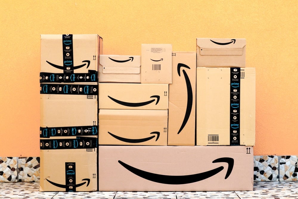 A stack of packages, with the Amazon logo on them.